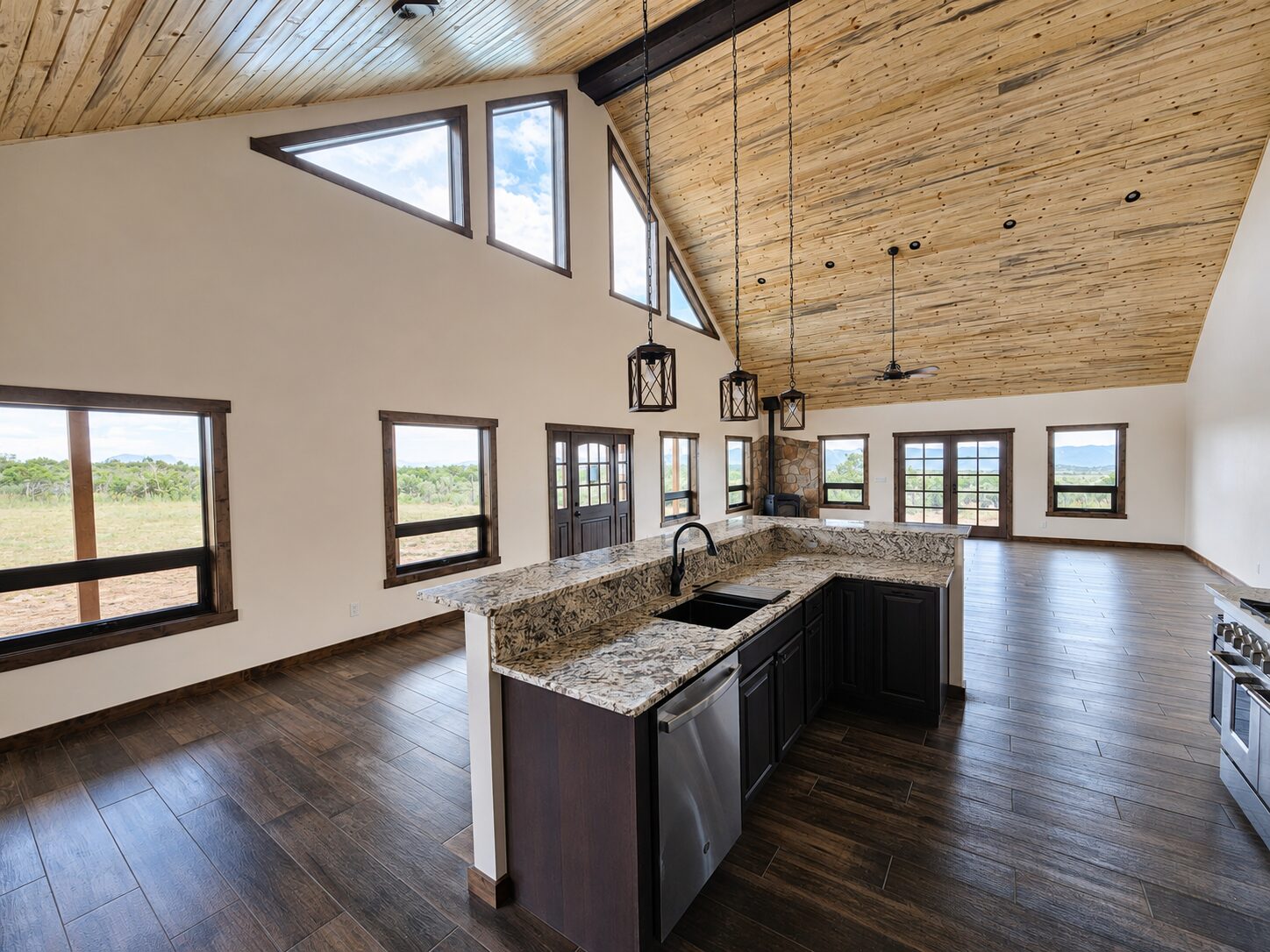 Great room looking into the kitchen with vaulted ceiling
