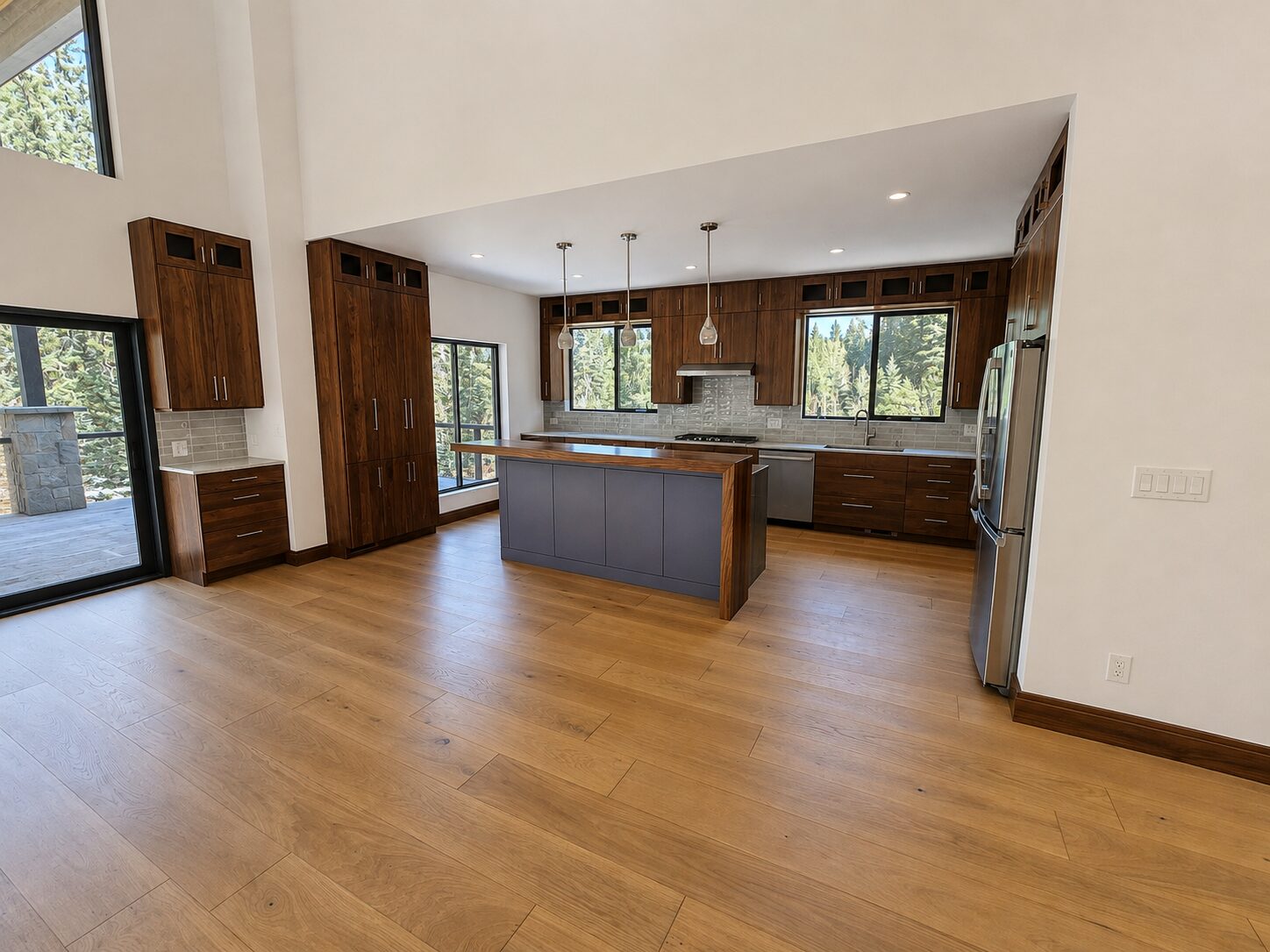 Open-concept great room and kitchen with wood floors