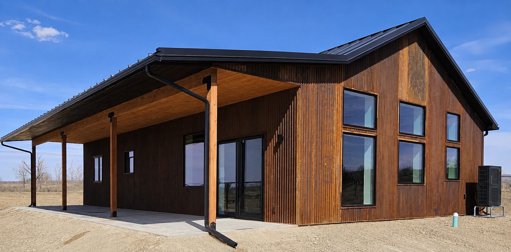 Two-story custom home rear elevation with wrap-around deck